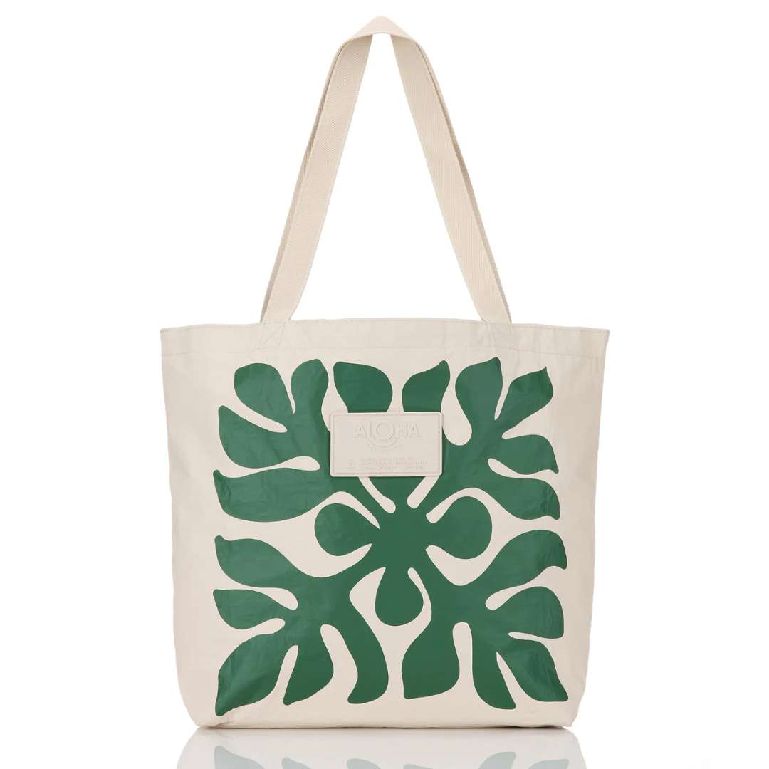 Beige tote bag with green leaf pattern on a white background