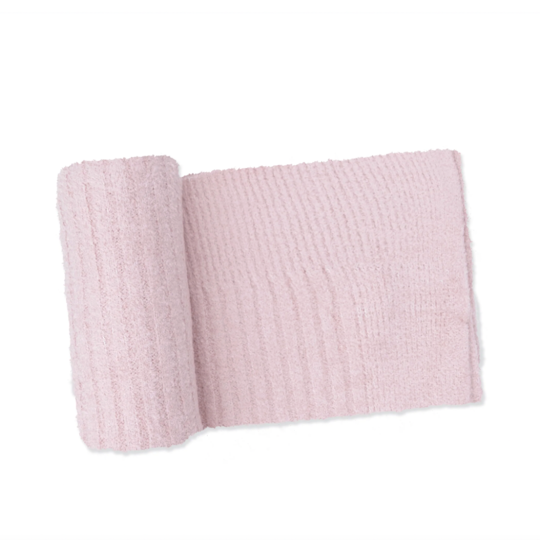 A light pink ribbed knit blanket with a matching rolled plush insert, displayed on a clean white background.