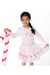 A young girl modeling a light pink long-sleeve dress with a ruffled collar, a light blue waistband, and red and white candy cane motifs on the bodice and tutu skirt. She is holding a large red and white striped candy cane prop against a solid white background.