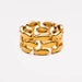 A gold-toned link ring featuring organic, leaf-like or fish-shaped interlocking links, photographed on a clean white background.