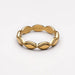 A gold ring with a wavy, scalloped edge and raised oval links separated by beaded borders, shown on a clean white background. The inside of the ring is engraved with the brand name 'ATOLEA'.