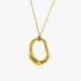 A gold abstract open pendant necklace on a delicate gold chain, shown against a plain light gray background.