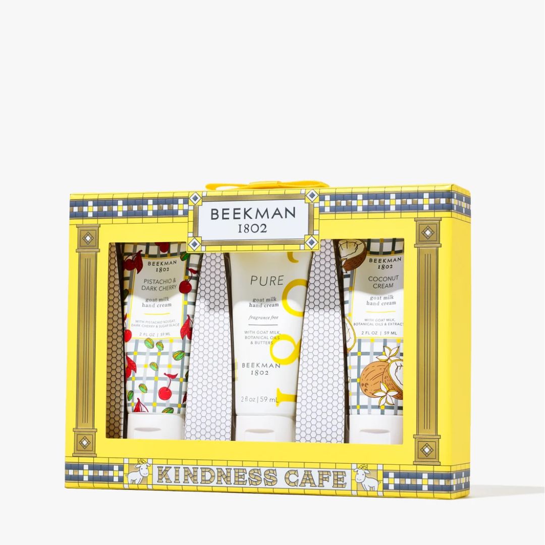 Beeeman 1802 Kindness Cafe gift set containing six hand and body care products in a bright yellow gift box with blue and gold patterned borders.