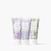 Three Beekman 1803 goat milk hand cream tubes in lilac, lavender, and eucalyptus scents, arranged side-by-side on a clean white background.