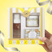 A hand holds a gift set box from Beekman 1802, containing a coconut cream body wash and coconut cream eye cream, with a gold seal and 'GOAT GOAT' branding, set against a yellow background with decorative ribbons.