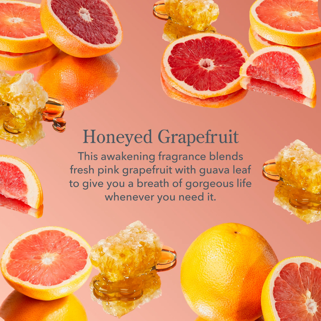 A pink fragrance-themed graphic with the text 'Honeyed Grapefruit' and a descriptive scent note, surrounded by floating grapefruit slices, whole grapefruit, honeycomb, and orange slices on a pink background.