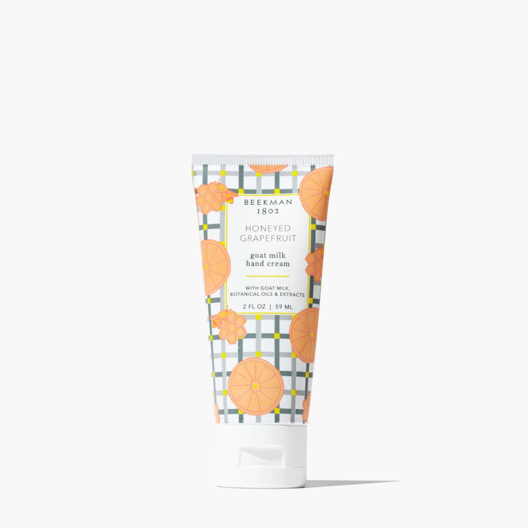 Tube of Beekman 1802 Honeyed Grapefruit goat milk hand cream on a white background