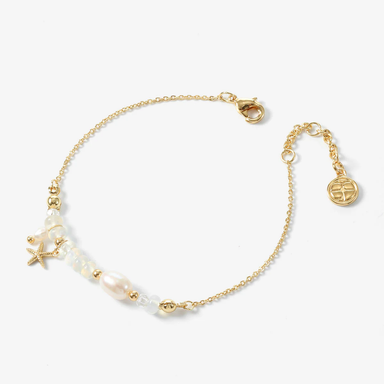 Gold bracelet with pearls on a white background