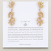 Gold coral-themed earrings on a 'CURRENT' branded card with a quote by Bryan Anthonys.
