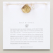 Gold shell necklace on a card with text and branding