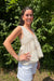 Woman wearing tan and white striped V-neck blouse