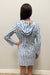 Woman wearing blue and white striped dress with lace up neck