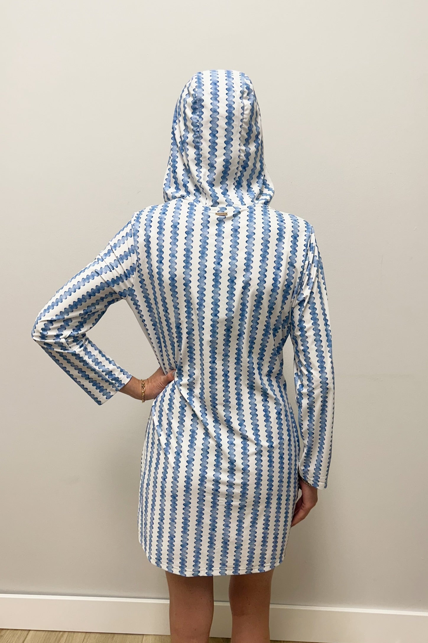 Woman wearing blue and white striped dress with lace up neck