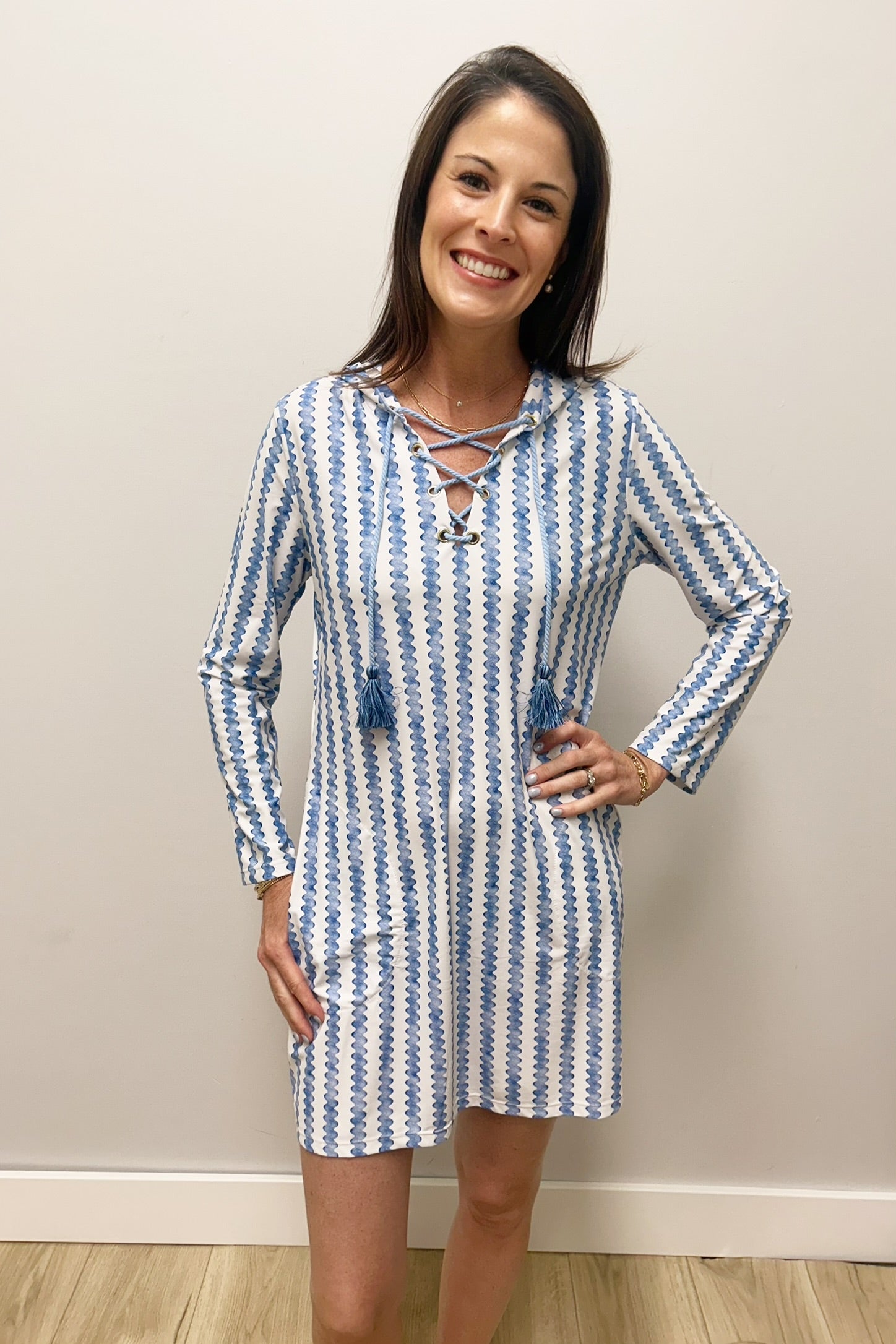 Woman wearing blue and white striped dress with lace up neck