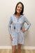 Woman wearing blue and white striped dress with lace up neck