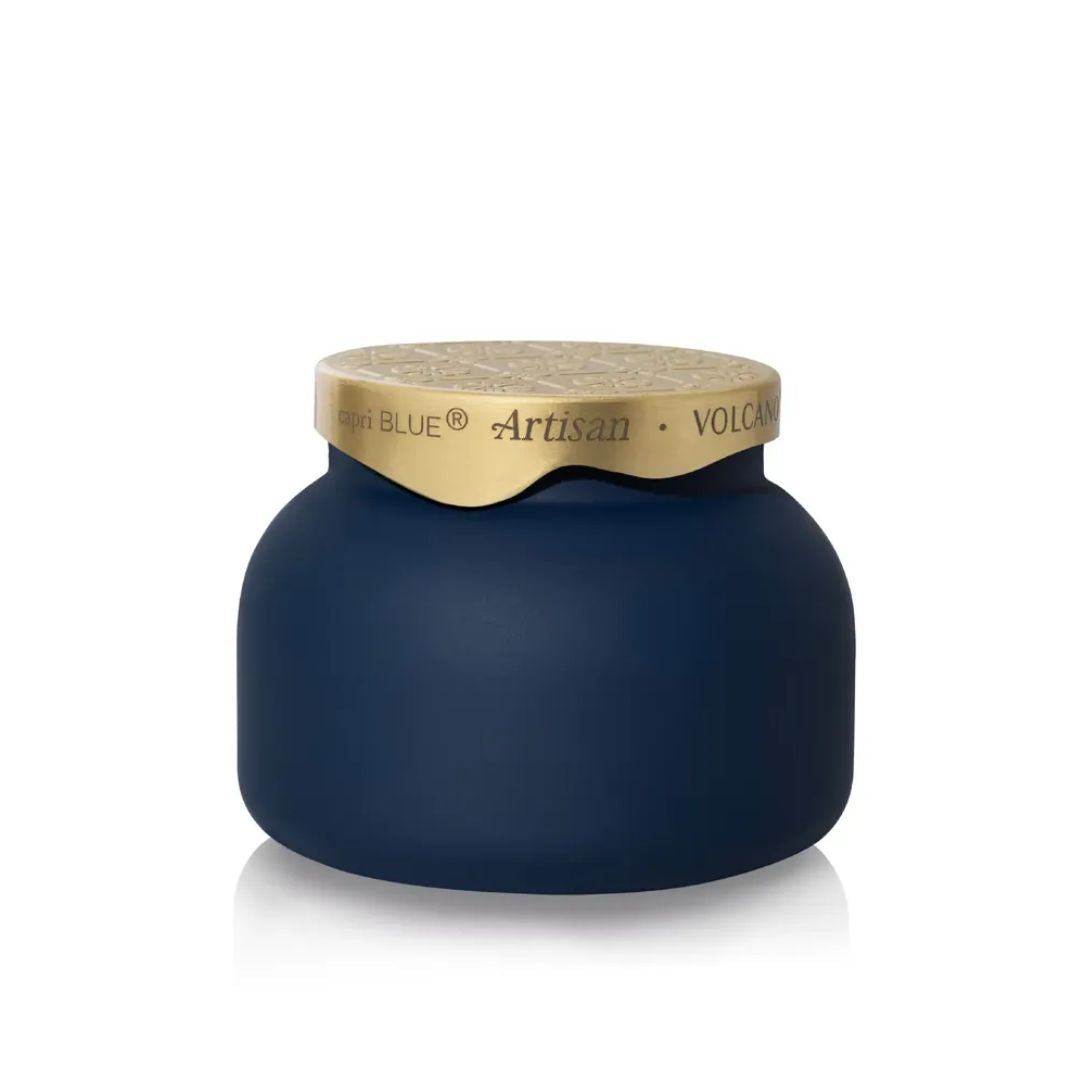 A dark navy blue jar with a textured gold lid, featuring the brand name 'HIGH BLUE' and product name 'Artisan VOLCANIC' printed on the lid, set against a plain white background with a soft reflection.