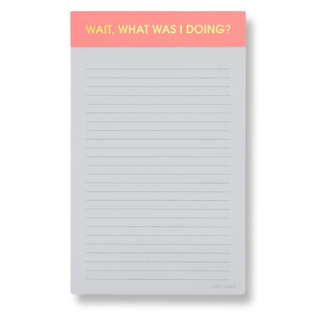 A lined notepad with a coral pink header that reads 'WAIT, WHAT WAS I DOING?' in yellow text, shown on a white background.