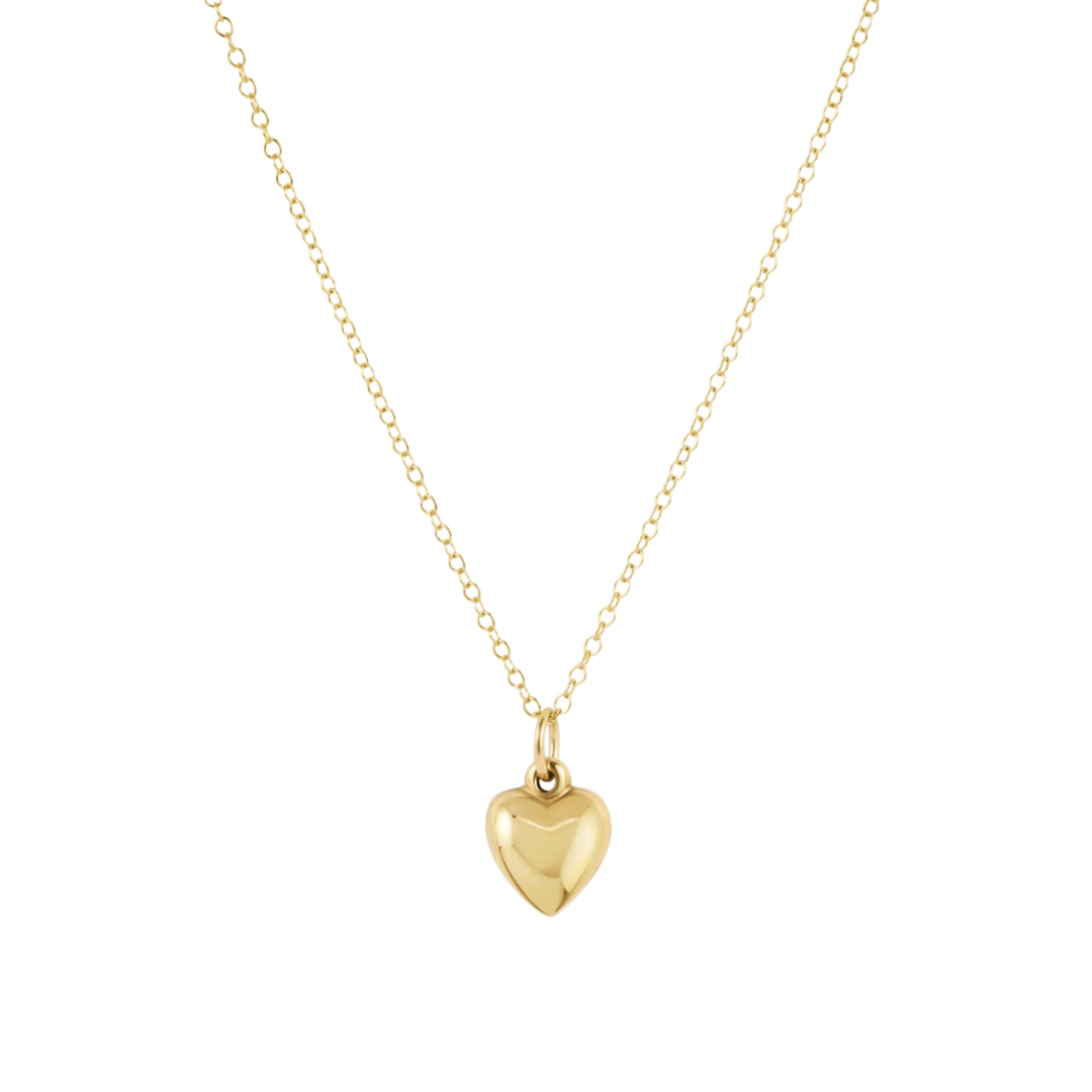 A delicate gold chain necklace featuring a polished, smooth heart-shaped pendant, presented on a clean white background.