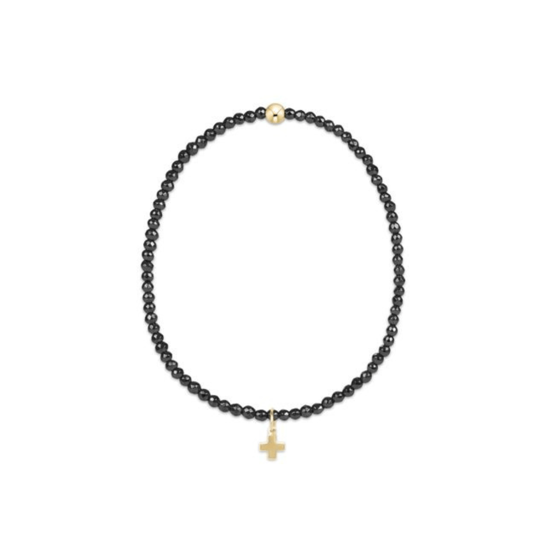 Black beaded necklace with a gold cross pendant on a white background