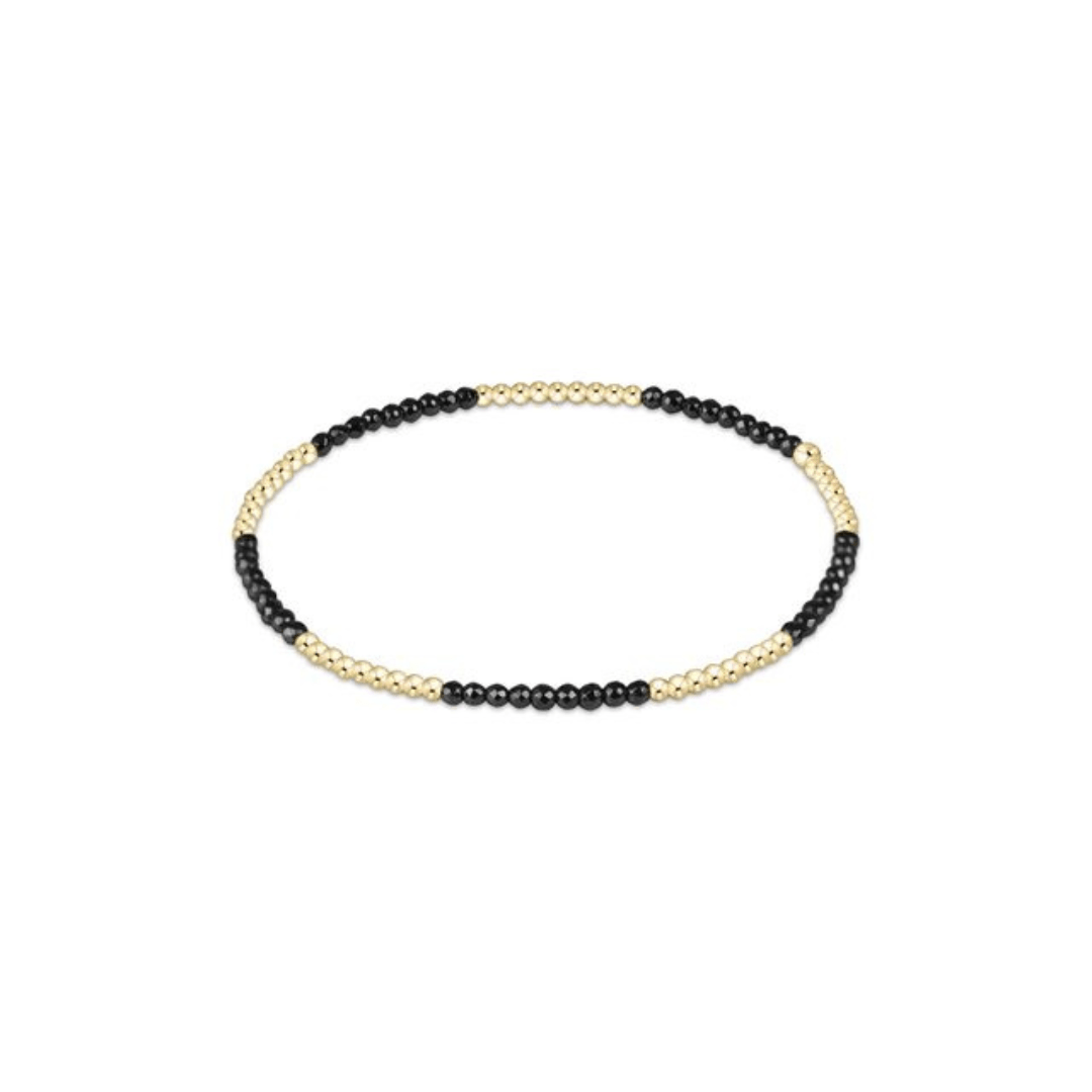 Necklace with black and gold beads on a white background