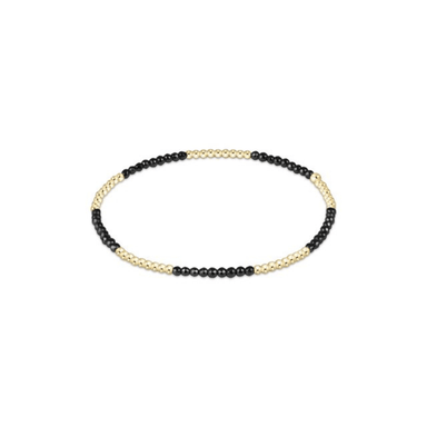 Necklace with black and gold beads on a white background