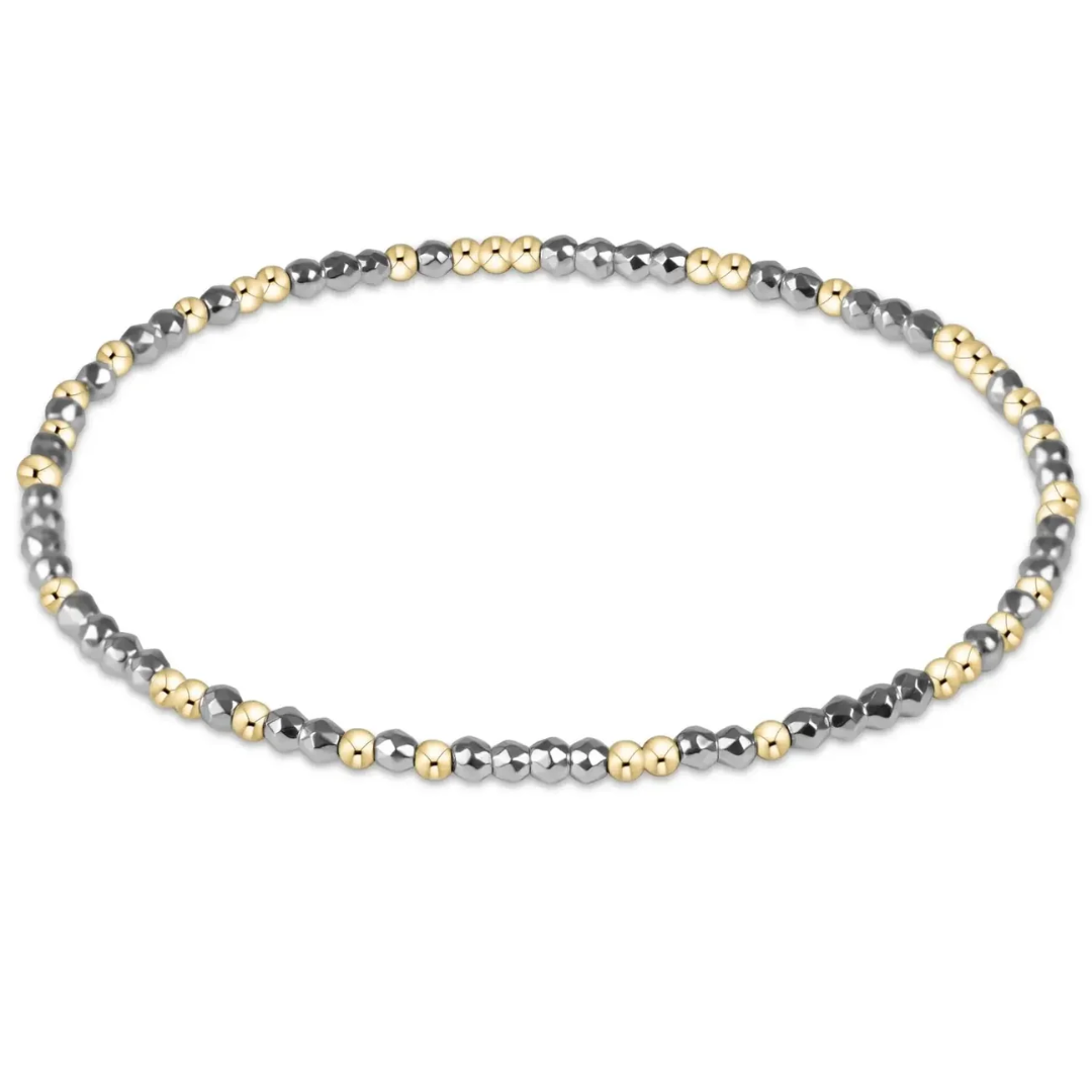 Bracelet with alternating gold and silver beads on a white background