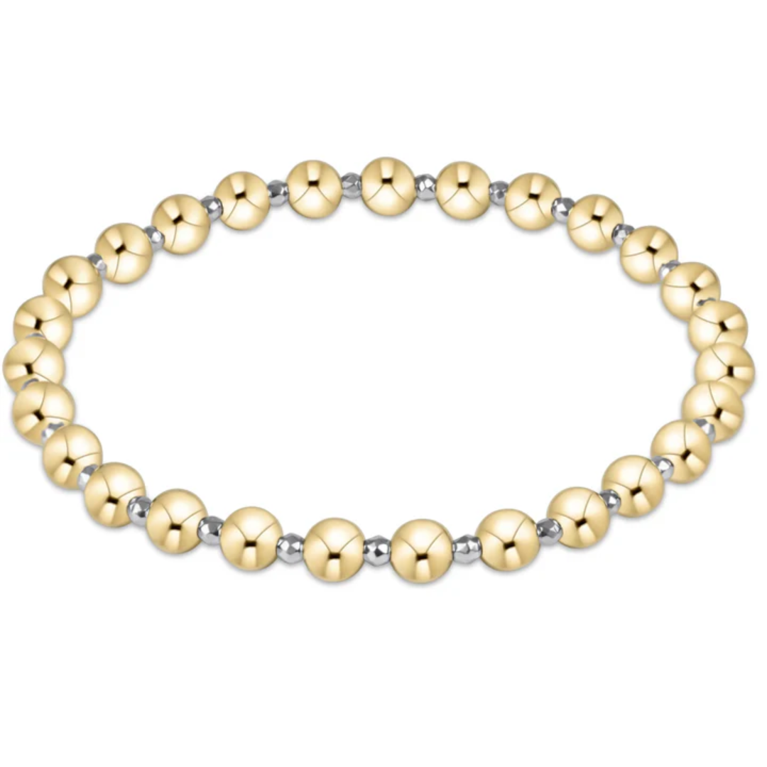 gold and silver bracelet against white background