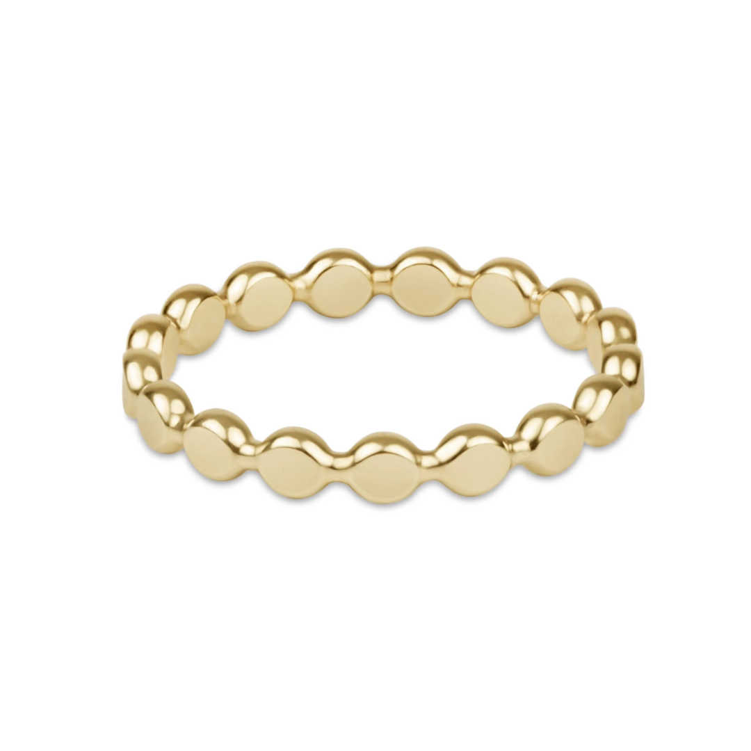 A gold beaded stretch band ring with a wavy, scalloped edge design, shown on a plain white background.