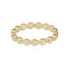 A gold beaded stretch band ring with a wavy, scalloped edge design, shown on a plain white background.