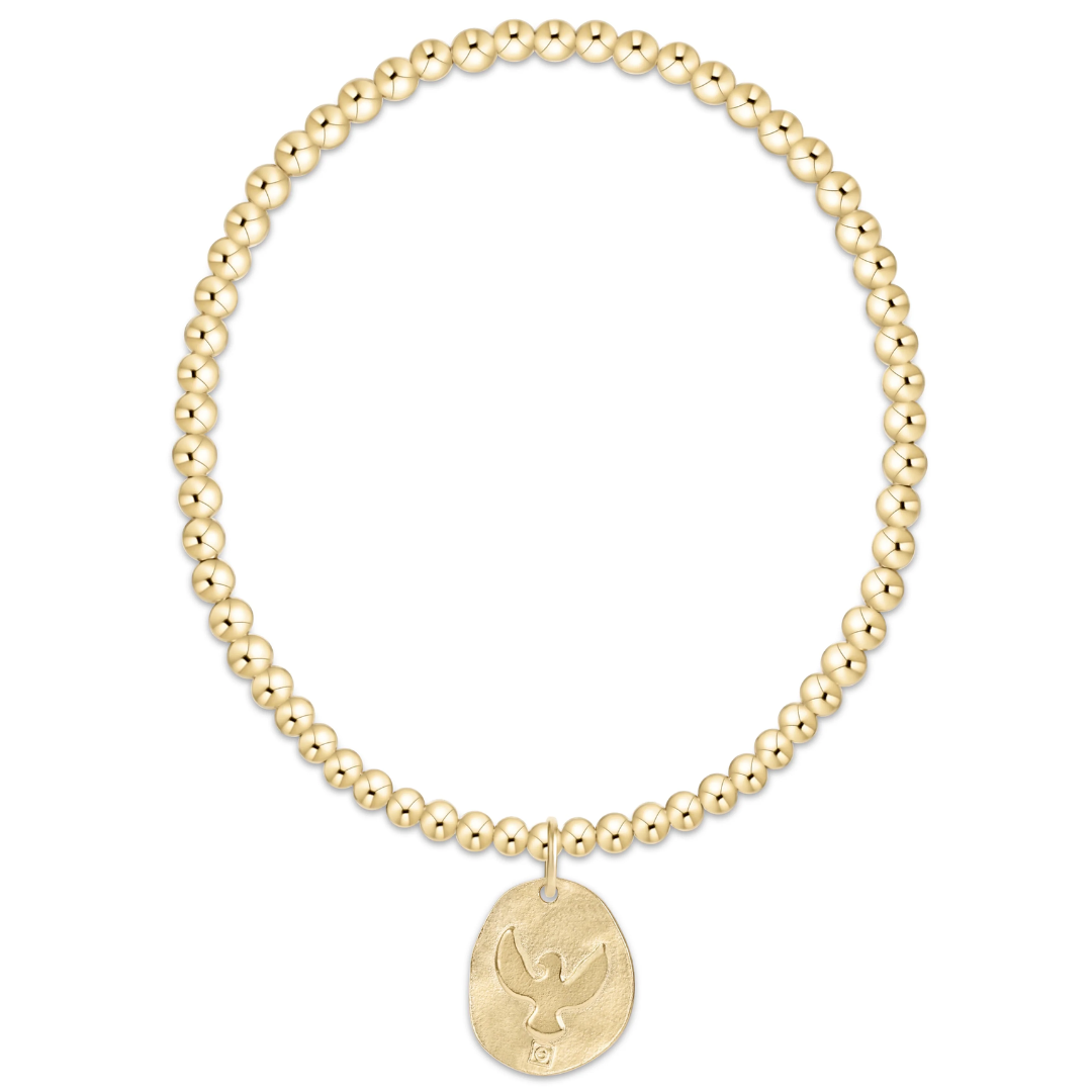 Gold beaded bracelet with a gold dove pendant on a white background