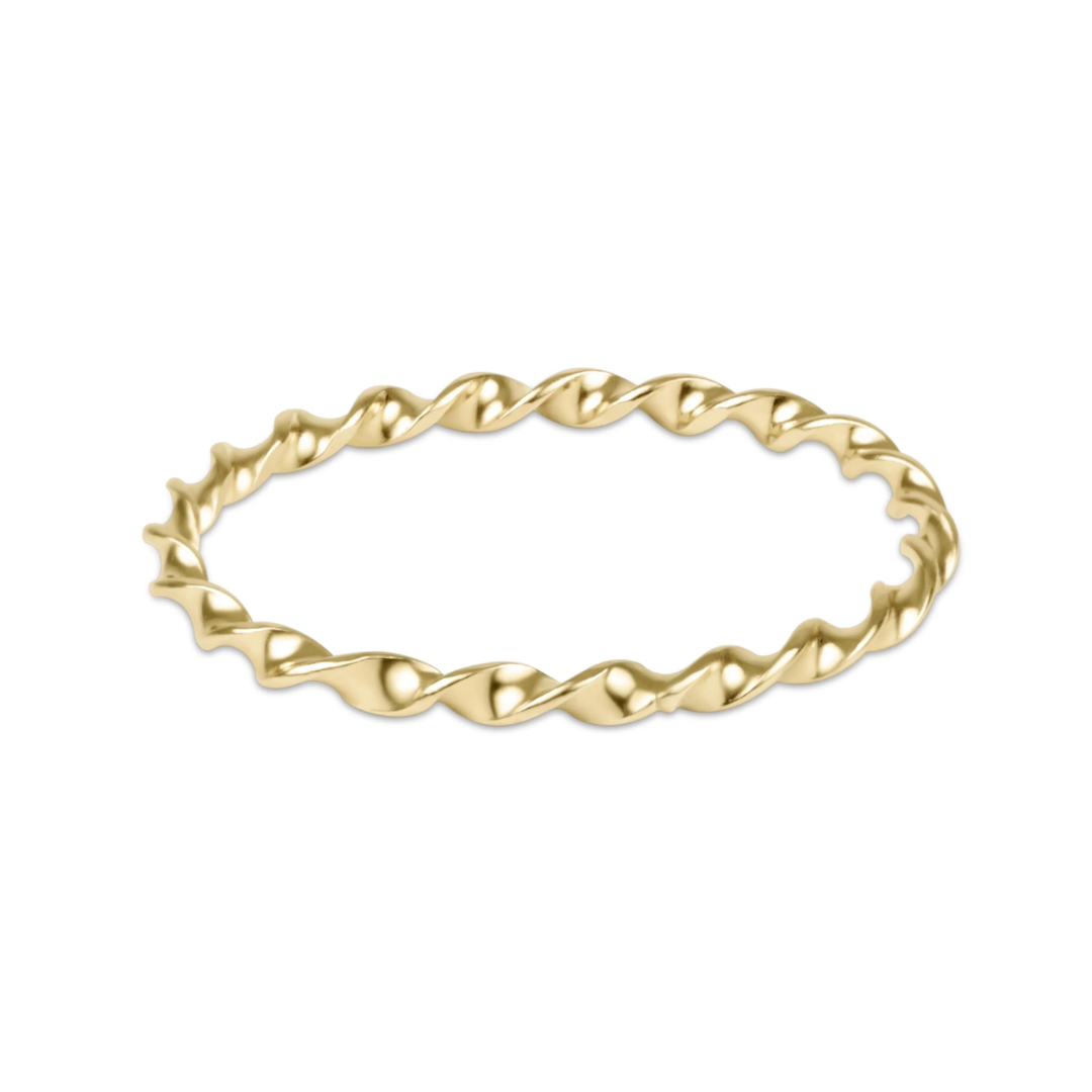 A twisted rope-style gold bangle bracelet on a plain white background.