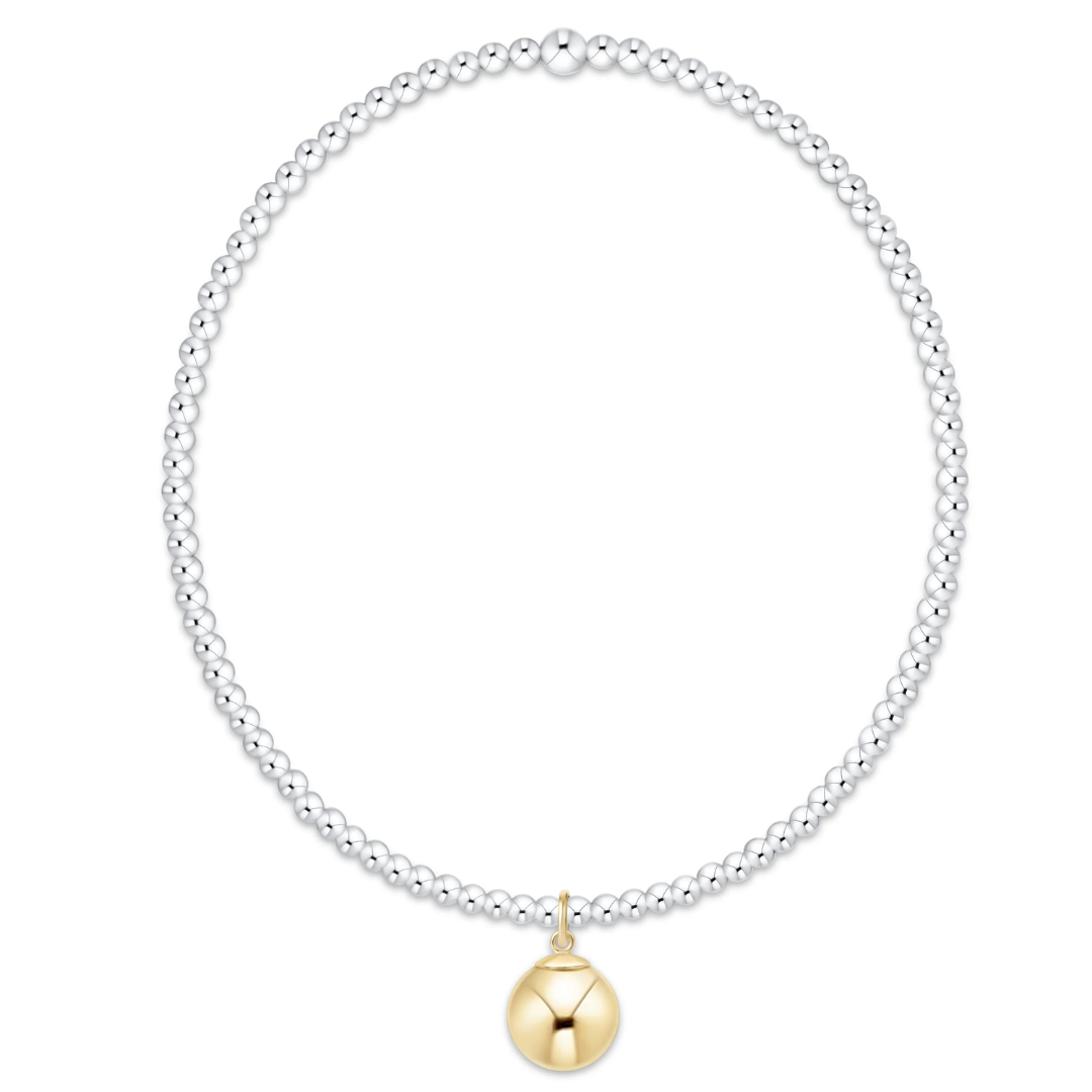 A silver beaded necklace with a polished gold bell-shaped pendant, displayed on a clean white background.