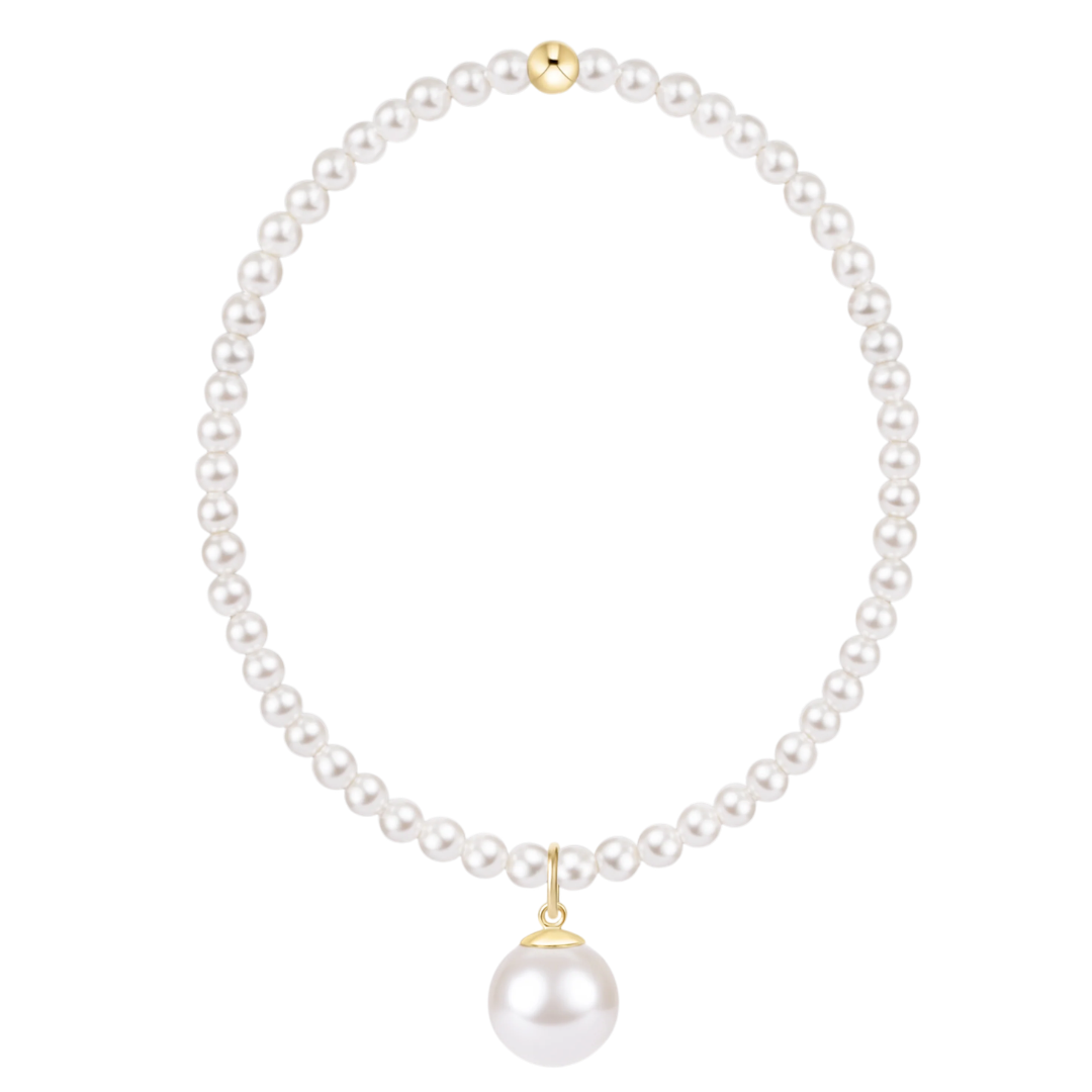A classic pearl necklace with a single large pearl pendant, accented by gold-toned metal findings at the clasp and pendant cap, shown on a solid white background.
