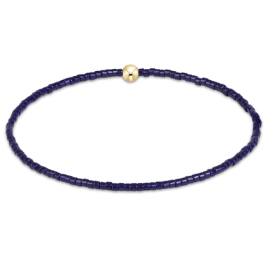 Navy blue beaded necklace with a gold clasp on a white background
