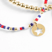 Bracelet with gold beads and star charm on a white background