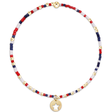 Necklace with red, white, and blue beads and a gold star charm on a white background