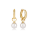 A pair of gold huggie hoop earrings with a dangling white pearl, shown on a clean white background.