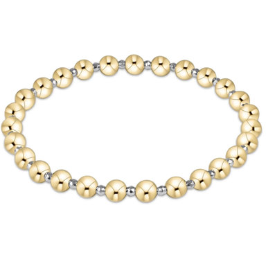 Gold beaded bracelet on a white background