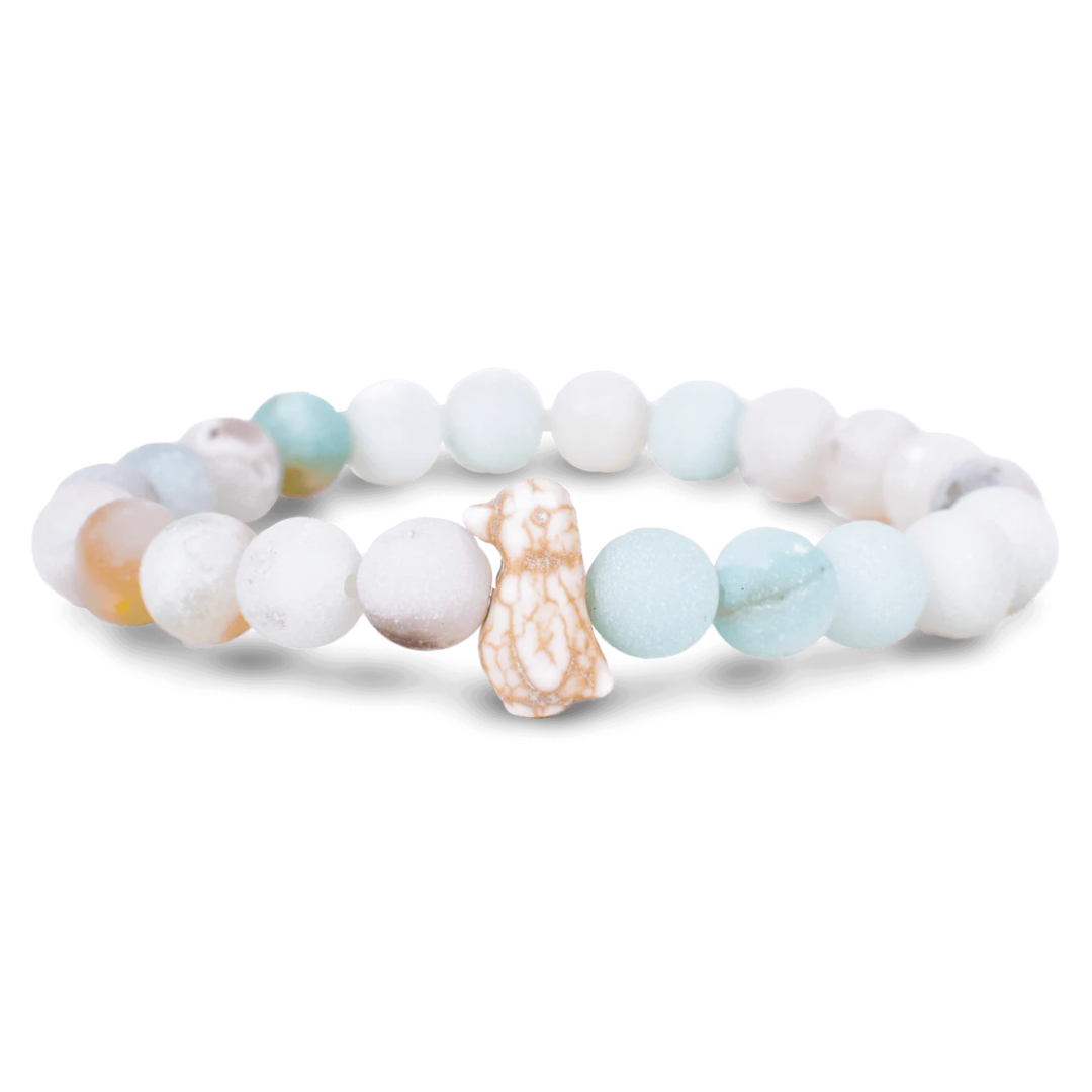 Beaded bracelet with a small figurine on a white background