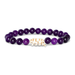 Purple beaded bracelet with a gold tiger head charm on a white background