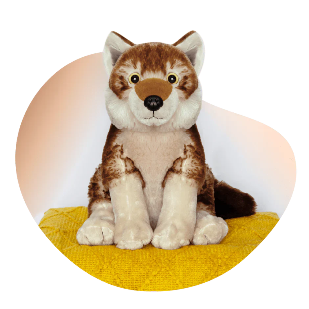 wolf plush on yellow blanket in front of brown and white background