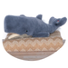 Plush whale toy on a round wooden platform with a zigzag patterned cushion