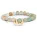 Multicolored beaded bracelet with a decorative element on a white background