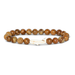 Beaded bracelet with a white charm on a white background