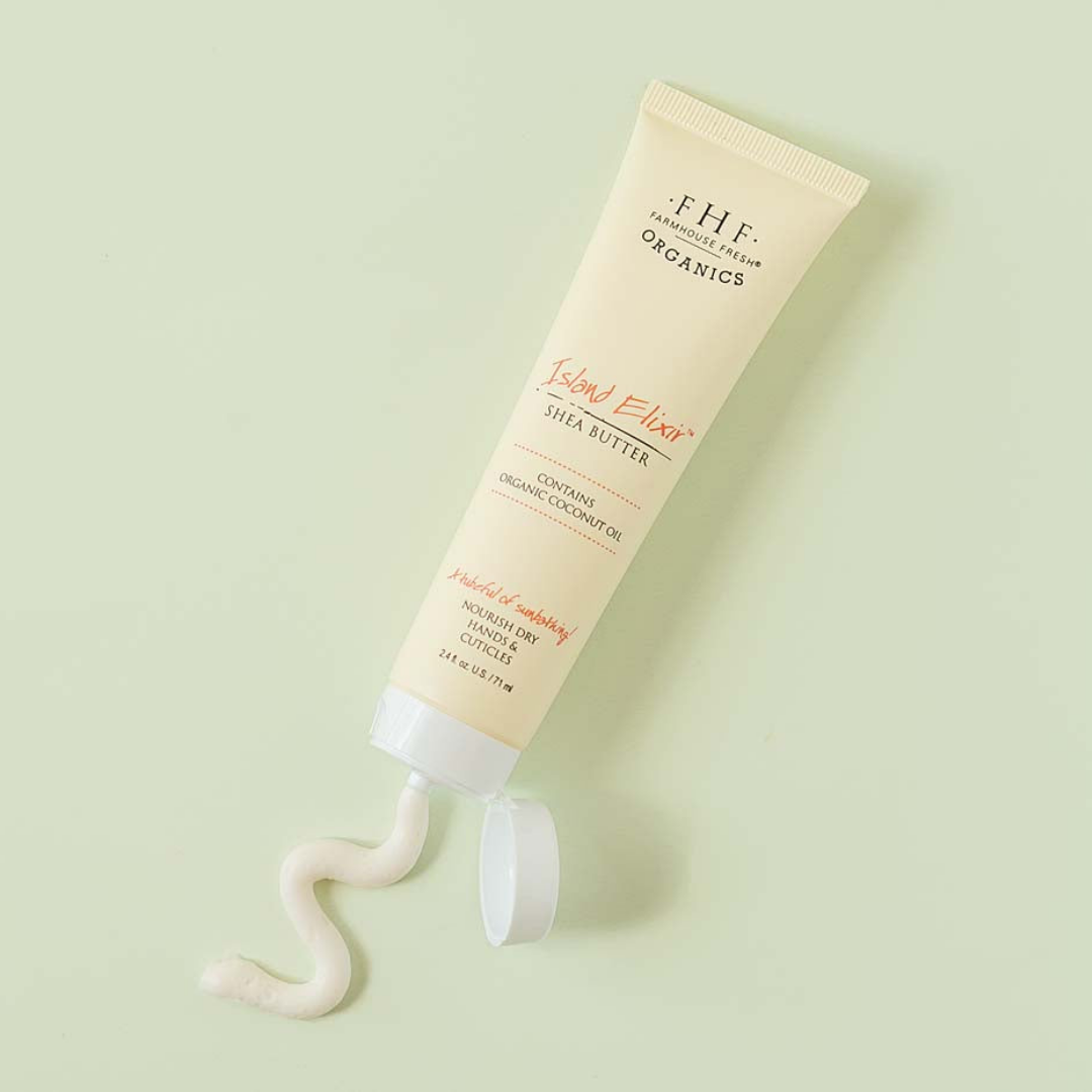 A squeeze tube of EHF Organics Salon Floor Shea Butter Conditioner, with a squiggle of white cream and the white cap placed beside it on a pale green background.