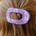 purple hair clip in models hair