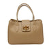 Beige handbag with a gold clasp on a white background