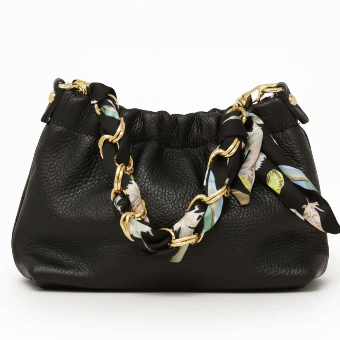 Black handbag with floral-patterned chain strap on a white background