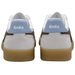 A pair of Gola sneakers shown from the back, featuring a light gray suede and white leather upper with brown suede side panels, a light blue heel tab with the white Gola logo, and a gum rubber sole.