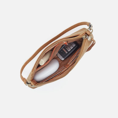Open tan leather pouch with a black device on a white background